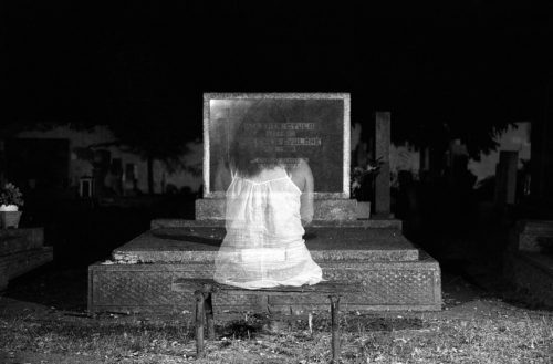 ghost girl sitting in front of a computer or TV