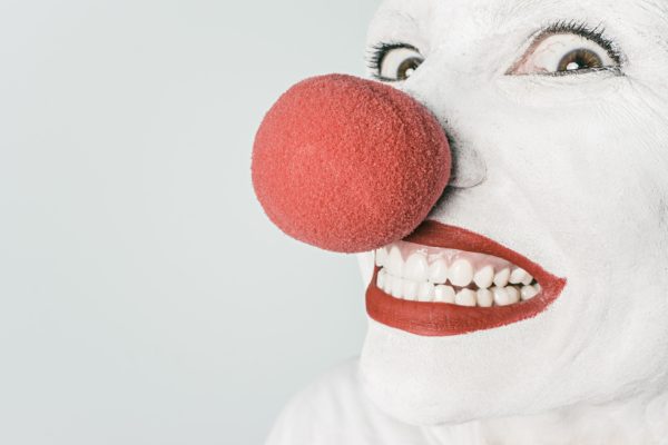 Clown with big red nose smiling