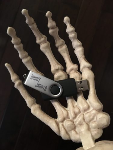 Skeleton hand holding USB