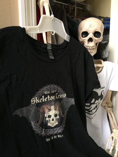 Skeleton in Closet holding shirt