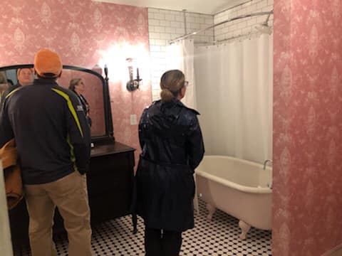 Couple touring haunted room 311 bathroom at the Read House hotel