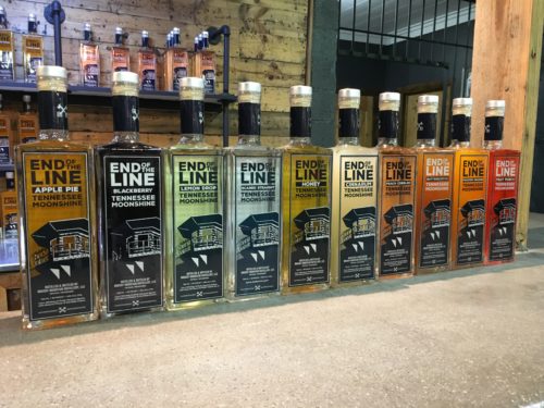 A row of End of the Line Moonshine bottles