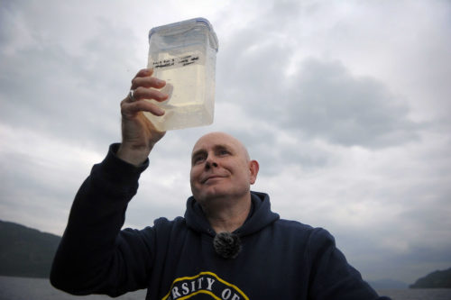 Dr. Neil Gammell collects eDNA samples from the waters of Loch Ness