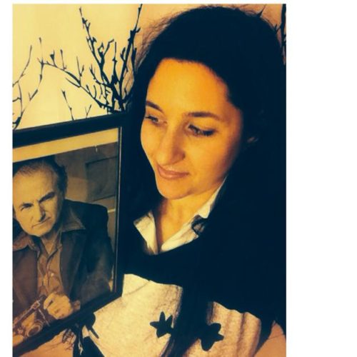 Alexandra Holzer with a photo of her father Hans Holzer