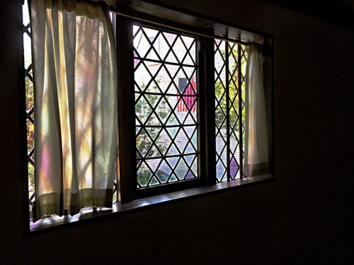 17th century window pane with American flag view