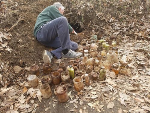 A man excavating the bottles at the 1886 Crescent Hotel & Spa