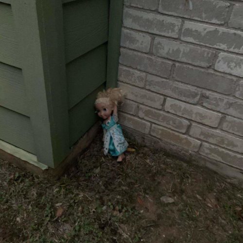 Alleged haunted Frozen Elsa doll propped against side of house