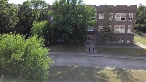 Amy and Adam standing in front of Farrar School