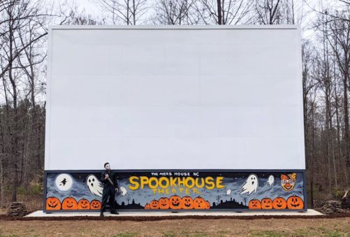 The Myers House NC Spookhouse Theater movie screen with Michael Myers holding a knife in front of it