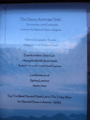Sign of haunted accolades on window at the Historic Anchorage Hotel