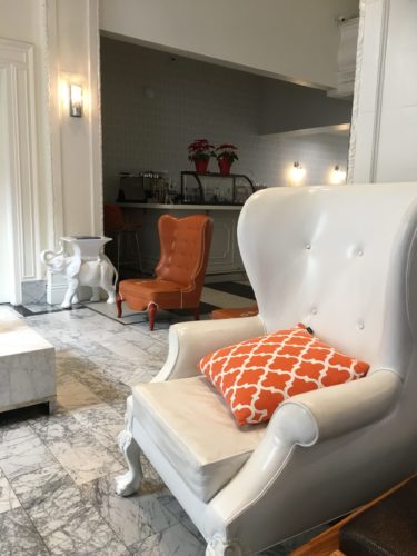 Orange and white wing chair in Hotel Vertigo lobby