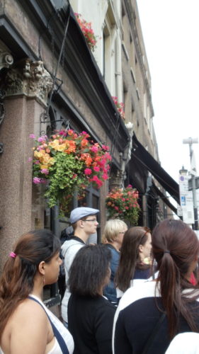 Jack the Ripper Tour Goers listening to the guide at a Ripper point of interest