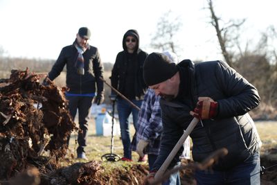 Jason Hawes digs underneath witching tree to search for evidence.