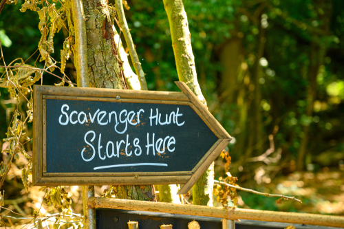 Scavenger Hunt Starts Here chalkboard sign in outdoors