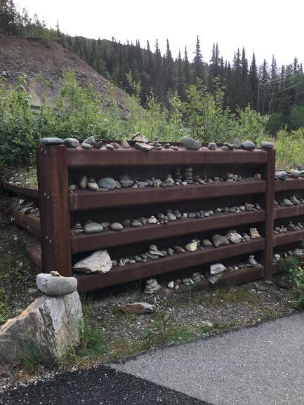 Inukshuks in path-side wall along George Parks Highway 7