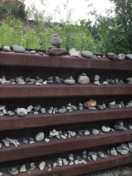 Inukshuks in path-side wall along George Parks Highway 4