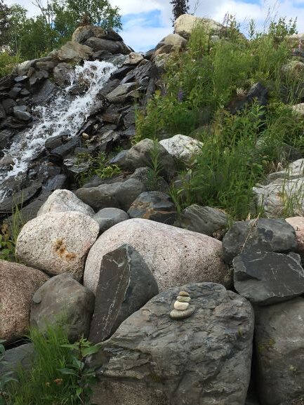 Inukshuks on bank of creek at Mt McKinley Wilderness Lodge 2