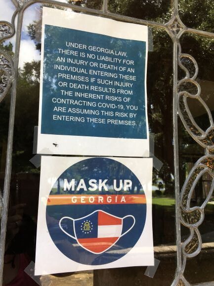 Close-up of Mask Up Georgia sign on Hollybourne Cottage