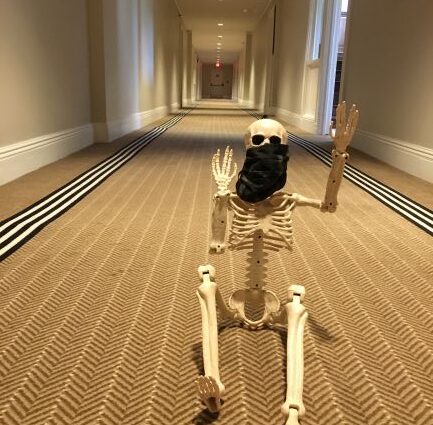 Skeleton wearing mask sitting inside the Jekyll Island Club hotel's hallway