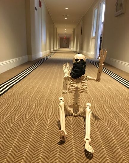 Skeleton wearing mask sitting inside the Jekyll Island Club hotel's hallway