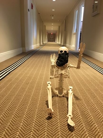 Skeleton wearing mask sitting inside the Jekyll Island Club hotel's hallway