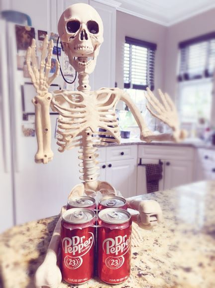 Smalls skeletn with mini cans of Dr. Pepper
