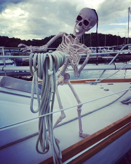 Smalls skeleton working the lines on a sailboat