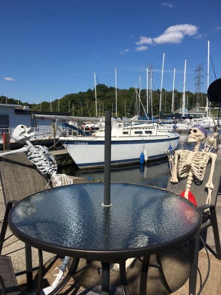 Mermaid and pirate skeleton at a dock