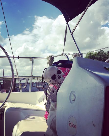 Smalls skeleton on a boat peeking out from behind a cooler