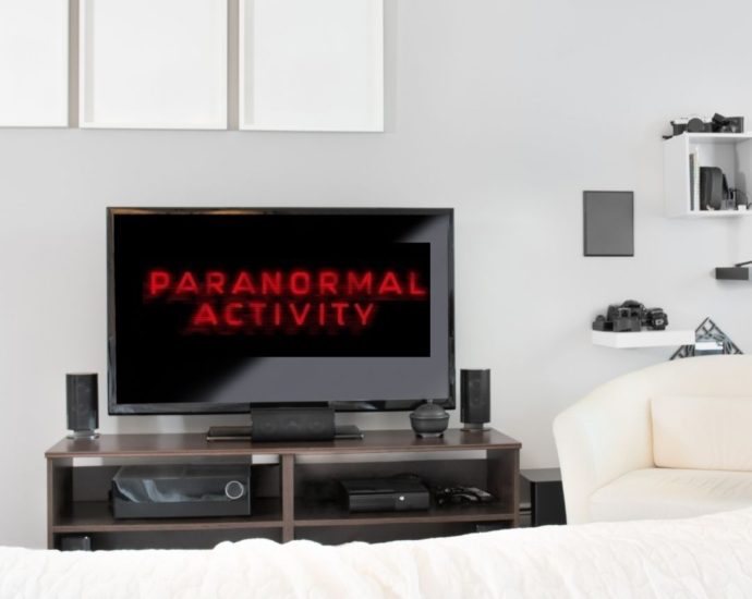 Paranormal Activity logo on TV in white bedroom