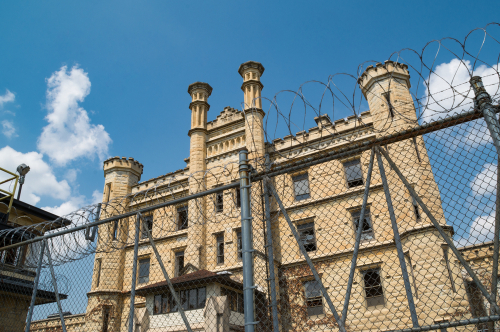 Exterior view of the Old Joilet Prison with fencing around it