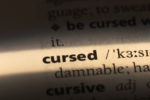 Photo of word cursed in a dictionary