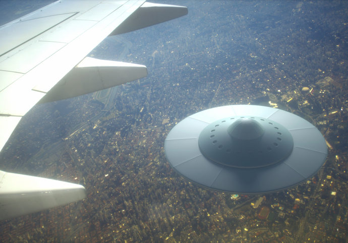 UFO under wing of an airplane in the sky