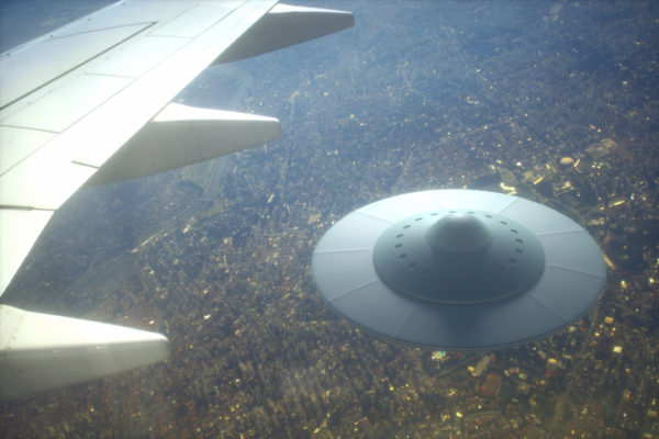 UFO under wing of an airplane in the sky