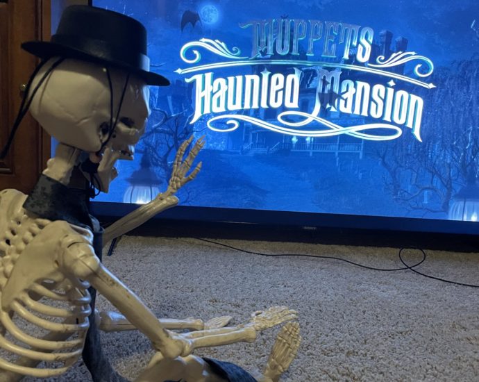 Skeleton watching Muppets Haunted Mansion on TV