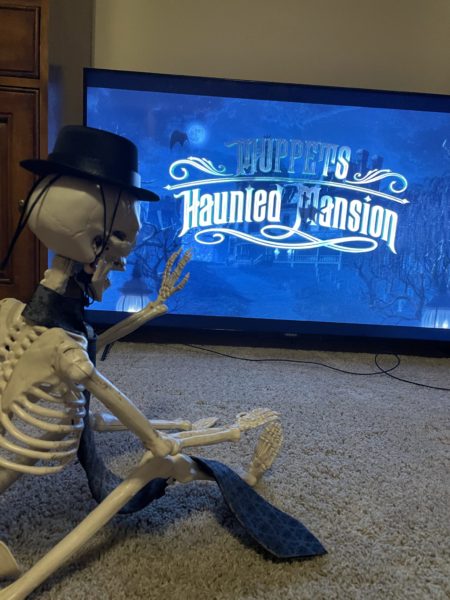 Skeleton watching Muppets Haunted Mansion on TV
