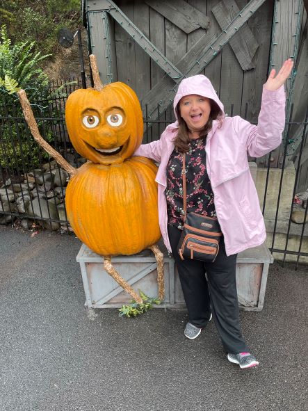 Woman posing with pumpkin figure