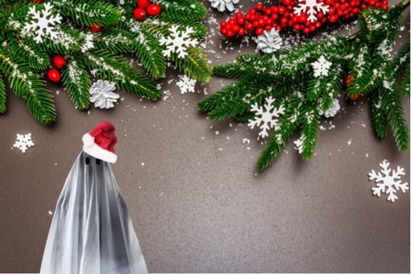 Evergreen Holly and Snowflake background with ghost in Santa cap