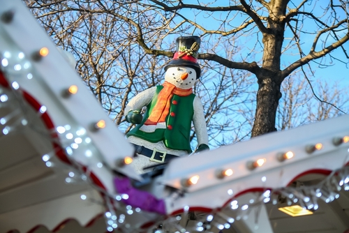 Making Merry Inflatable Snowman on Roof of house decorated for Christmas