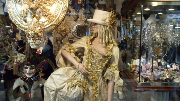 Carnival display of woman in gold in Venice shop window