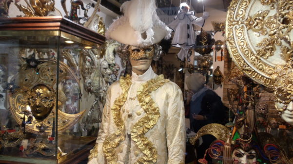 Carnival display of man in gold in Venice shop window