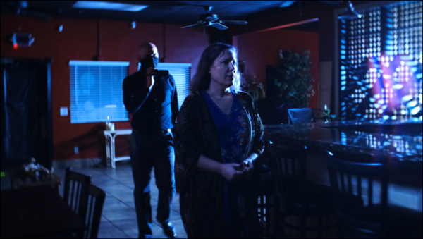 Medium Amy Allan walking through a South Carolina restaurant in an episode of The Dead Files
