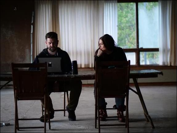 Jack Osbourne and Katrina Weidman analyzing evidence in Hill View Manor