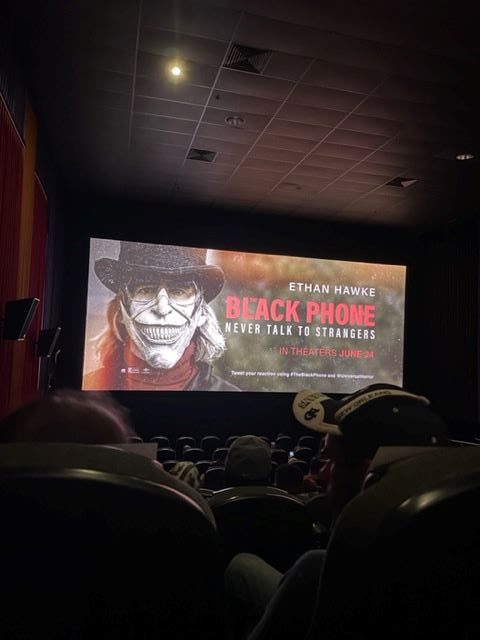 Black Phone poster on movie theater screen