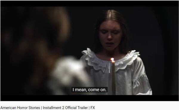 Screenshot of girl in white with candle from American Horror Stories season 2