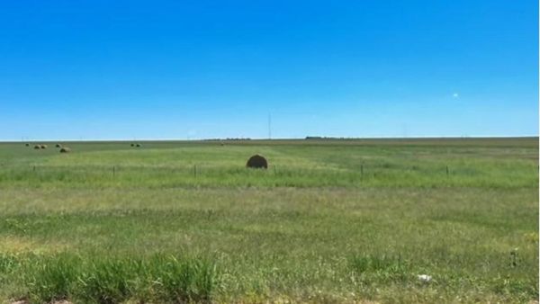 Photo of hay bales across the rolling Kansas landscape