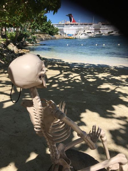 Smalls Skeleton on beach looing at Carnival cruise ship in Ocho Rios, Jamaica