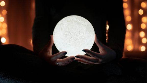 woman holding psychic glowing globe orb