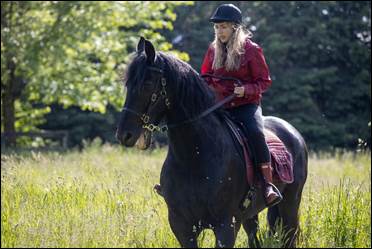 Girl on horse in Eli Roth Presents: My Possessed Pet
