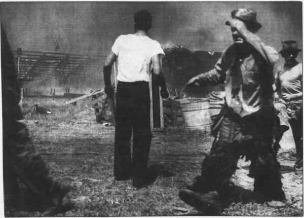 Newspaper photo of clown with a water bucket as the big top burns at Hartford Circus fire